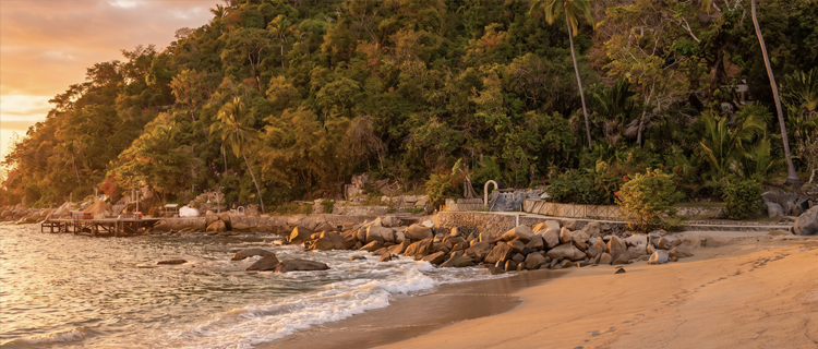 A secluded boat-only cove with clear water on the south shore of Banderas Bay