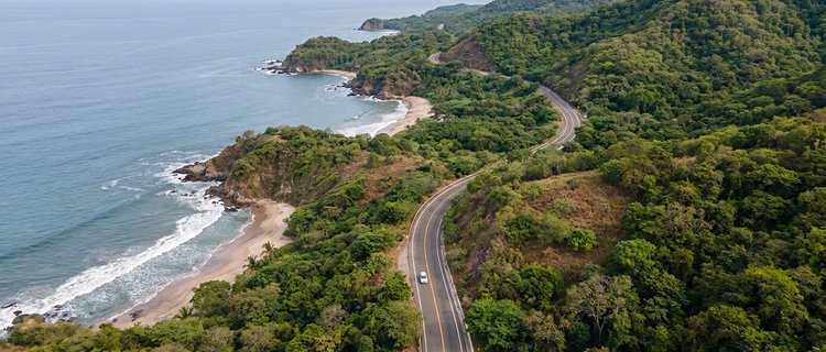 Highway 200 curving along the Riviera Nayarit coast toward Punta de Mita with the Pacific on the left