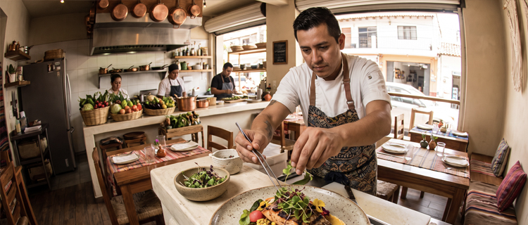 A chef plating a seasonal dish at a small Versalles restaurant in Puerto Vallarta