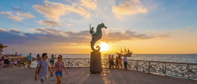 Bronze sculptures along the Malecon boardwalk in Puerto Vallarta at sunset